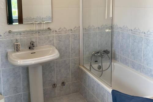 a bathroom with a sink and a shower at Hostal La Concha en Somo in Somo