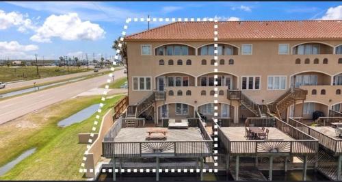 a large building with several decks and a road at 14334appt101 in Corpus Christi