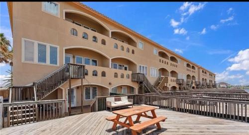 a building with a wooden bench in front of it at 14334appt101 in Corpus Christi