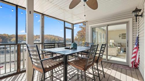 a dining room with a table and chairs on a balcony at Easy Breezy - Lakefront for 6 in Sunrise Beach