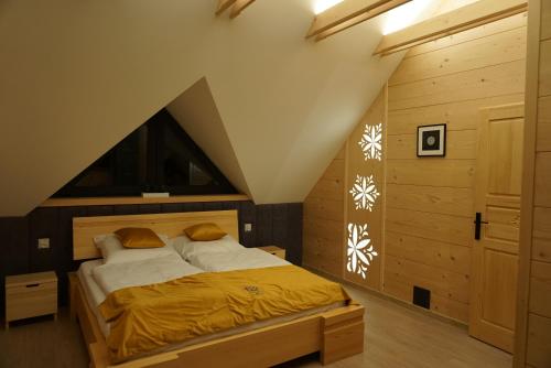 a bedroom with a large bed in a attic at Oaza Szczęścia in Koniaków