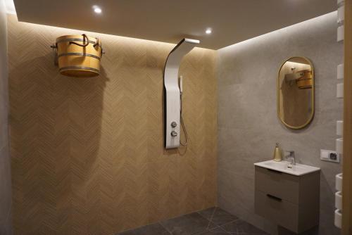 a bathroom with a sink and a light on the wall at Oaza Szczęścia in Koniaków