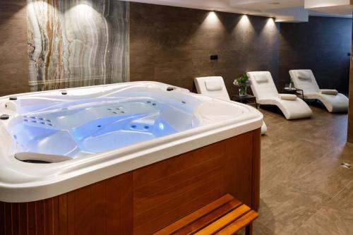 a large bath tub in a room with chairs at VIPo Prestige Apartments in Podstrana