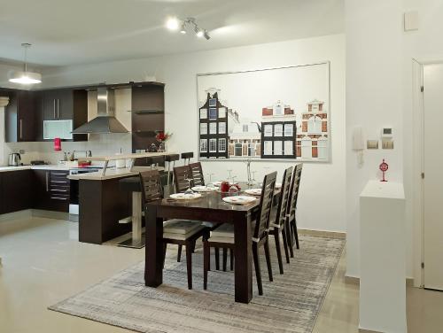 a kitchen and dining room with a table and chairs at Chloe Maxi Apt 108 sqm in Kastoria