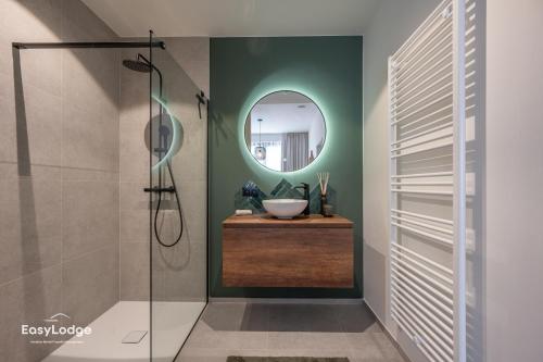 a bathroom with a sink and a mirror at FORTESSE - Luxury apartment near the sea with parking in Ostend