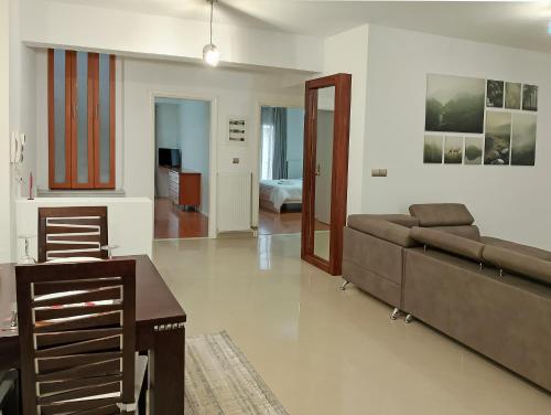 a living room with a couch and a table at Chloe Maxi Apt 108 sqm in Kastoria