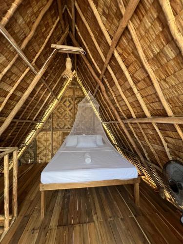 a hammock bed in a thatched room at Villa Fria private beach cottage in San Vicente