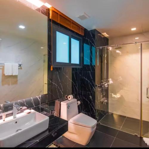 a bathroom with a toilet and a sink and a shower at Private Villa at Mida Grande Resort in Surin Beach