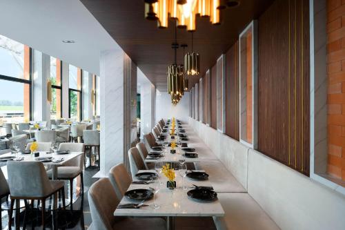 a long dining room with long tables and chairs at Private Villa at Mida Grande Resort in Surin Beach