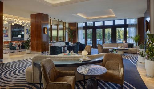 a lobby with a waiting area with couches and chairs at Cameo Beverly Hills, LXR Hotels & Resorts in Los Angeles