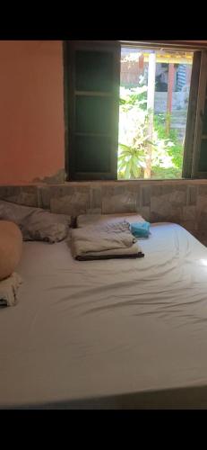 En eller flere senge i et værelse på Casa promoção Caraguatatuba