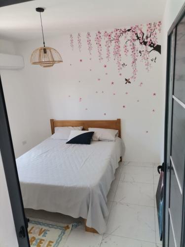 a bedroom with a bed with flowers on the wall at Serene Villa in Grand-Baie