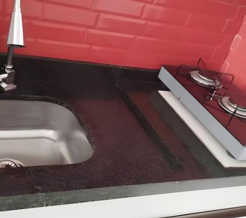 un bancone da cucina con lavello e fornello di Loft das Esrelas c/Ar p/4 a Volta Redonda