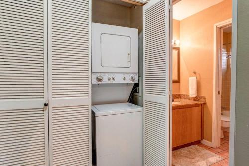 a small bathroom with a white washer and dryer at Kihei Resort 202 · KRS 202 Family Getaway 2BD w AC Pool Beach in Kihei