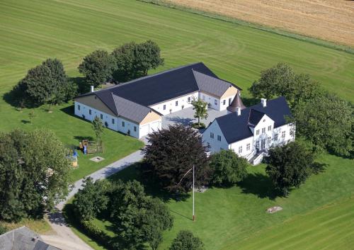 an aerial view of a large white house on a field at Kildebakkegaard Bed and Breakfast in Nørager