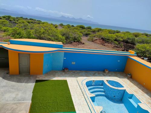 a house with a swimming pool on the side of it at Residencial Oliveira in Porto Novo