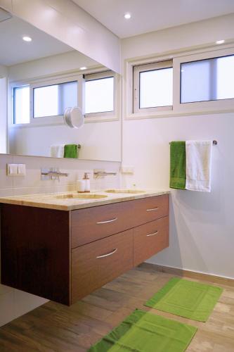 a bathroom with a large sink and a mirror at Holiday Apartment Sunset Ocean in Ribeira Brava