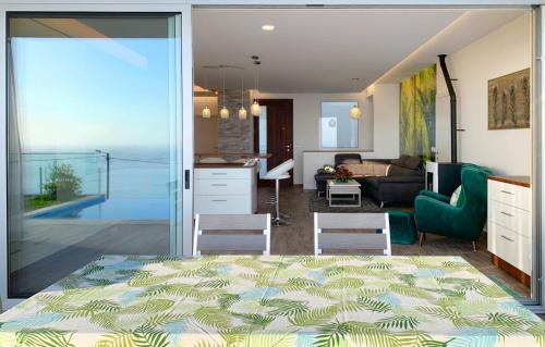 a living room with a view of a kitchen and a living room at Holiday Apartment Sunset Ocean in Ribeira Brava