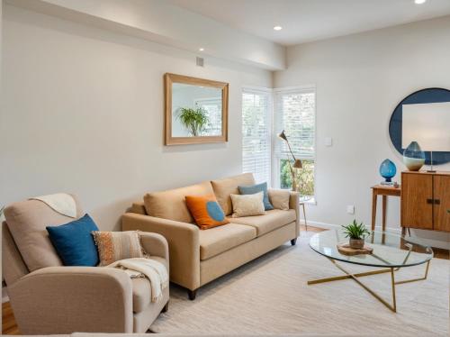 a living room with a couch and a table at Hollywood Living 3 to 5 BR Townhomes with Free Parking in Los Angeles