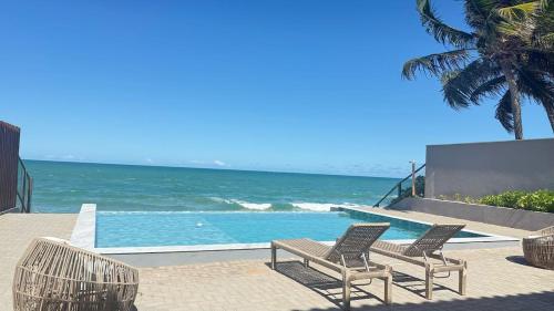 2 sedie e una piscina vicino all'oceano di Flat mar a Coruripe