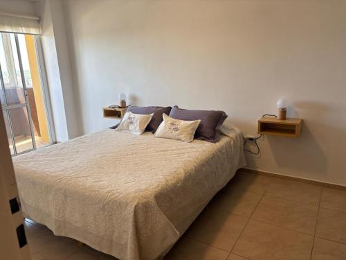 a bedroom with a bed with two pillows on it at Departamento Liban in San Juan