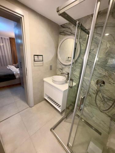 a bathroom with a shower and a sink and a mirror at 3 bedrooms villa with own pool! in Pano Dheftera