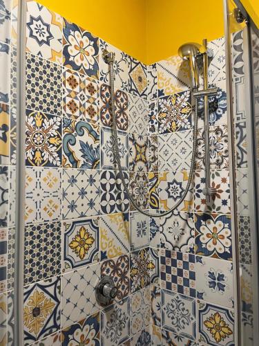 a bathroom with a bunch of tiles on the wall at Ciack si...dorme! in Taranto