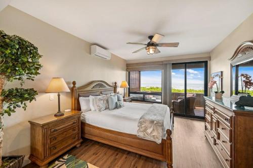 a bedroom with a bed with a ceiling fan at Kahana Village 36 · KHV 36 Oceanfront 3BD Kahana Condo, Beach & in Lahaina