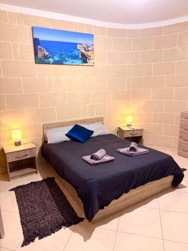a bedroom with a bed with two towels on it at St Anglu Xaghra - Quality Guest House in Xagħra