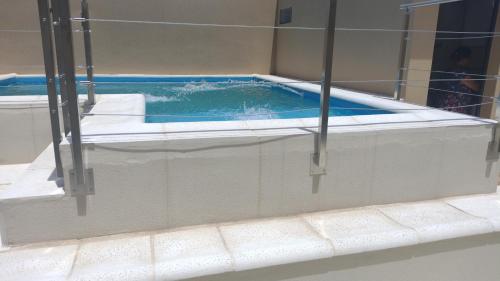 a bath tub with a pool of water at Loft Salto Chico in Concordia