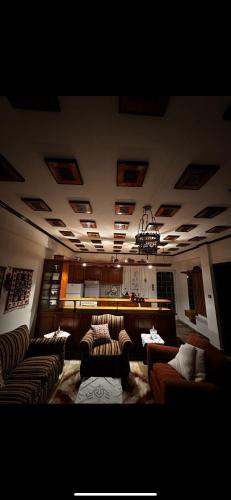 a large living room with couches and a piano at Kokkotis Residence in Samarina