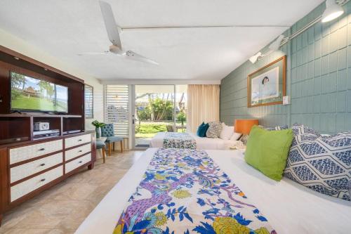 a bedroom with a bed and a tv in it at Napili Shores D126 · NSD126 Cozy Studio Steps to Beach in Kahana