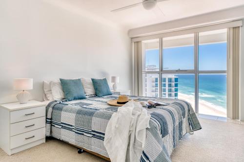 a bedroom with a bed with a view of the ocean at Talisman Beachside in Gold Coast
