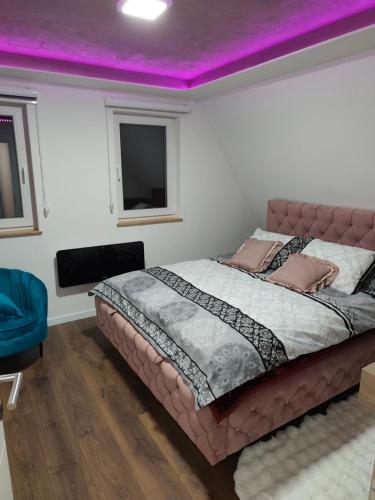 a bedroom with a large bed with a purple ceiling at Vila Dunja Pale in Pale
