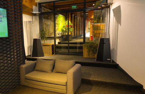 a couch sitting in the middle of a lobby at Planinska Kraljica in Gornje Pale