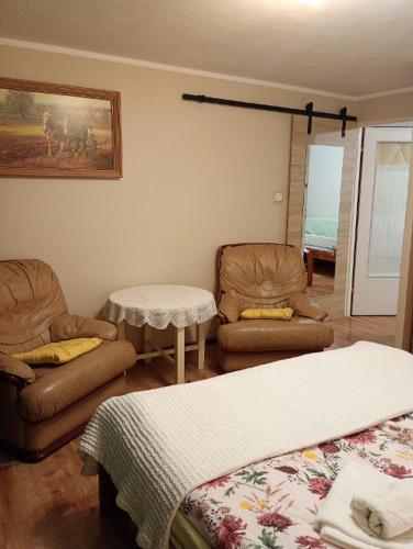 a room with two beds and a table and chairs at Jarzębinka in Wiele