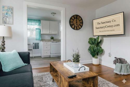 a living room with a couch and a coffee table at Villa Chic near Downtown Bristol King Bed in Bristol