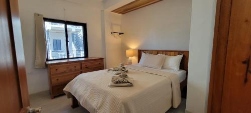 a bedroom with a bed and a window at Lickety Split Unit 3, Northside Ocean View in Caye Caulker