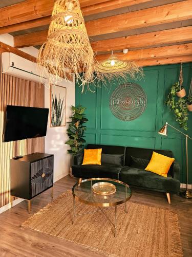 a living room with a black couch and a glass table at Apartamentos de la Huerta in Alicante