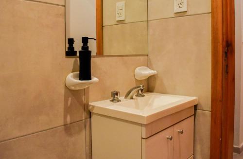 a bathroom with a sink and a mirror at Loft natural - Zona rio - Turismo! in Rosario