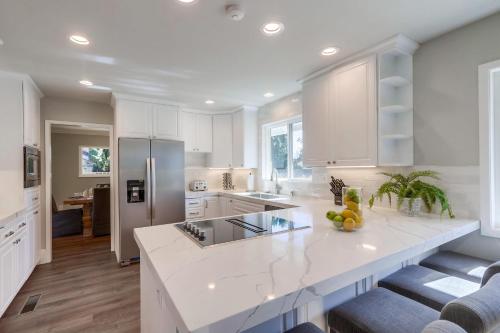 a kitchen with white cabinets and a white counter top at Destination #44 in Orange