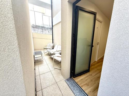 a hallway with a glass door to a living room at CC Room Gaia in Bicas