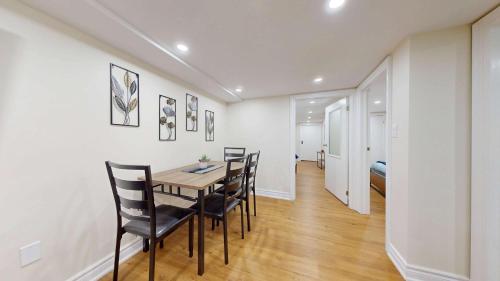 a dining room with a table and chairs at Stylish Basement Suite for 4 Near Cafes & Parks - Bloor Hotel in Toronto
