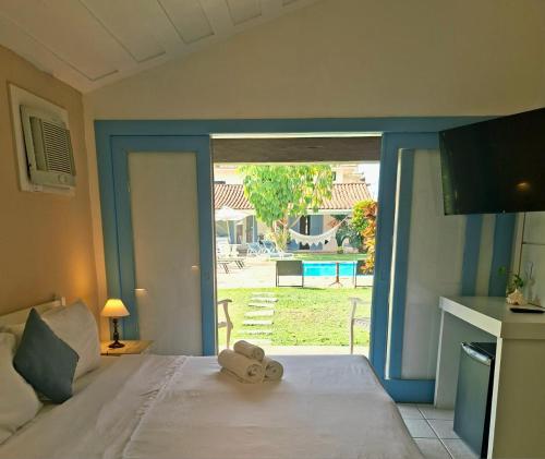 Ένα ή περισσότερα κρεβάτια σε δωμάτιο στο Pousada dos Pássaros Geribá