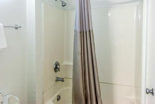 a bathroom with a shower with a shower curtain at Motel 6-Bakersfield, CA - East in Bakersfield
