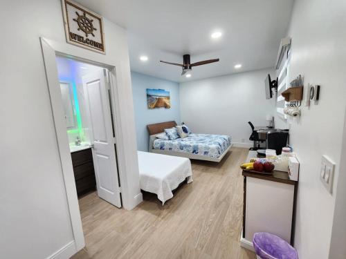 a small bedroom with a bed and a bathroom at Close to hard rock stadium and guitar casino in Pembroke Pines