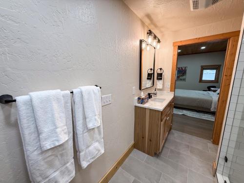 a bathroom with a sink and a mirror and towels at Lakefront Beauty in Rocky Point
