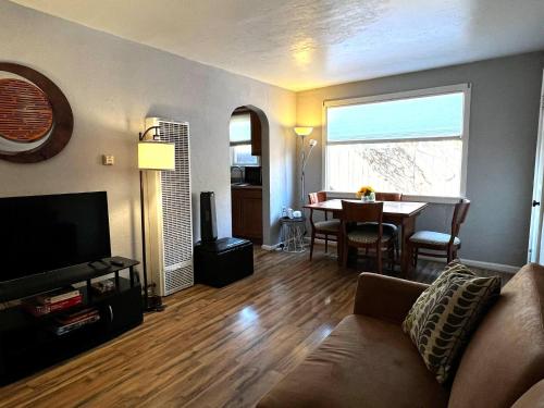 a living room with a couch and a table at Cute Bungalow 1 Mile from U of A in Tucson