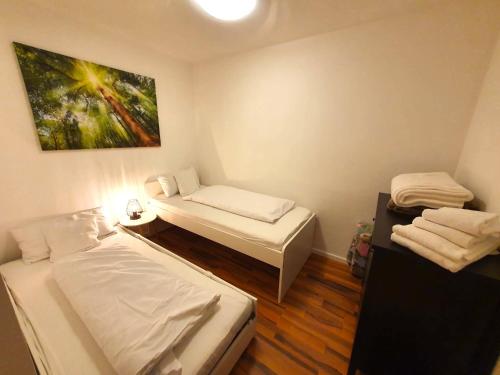 una stanza con due letti e un dipinto sul muro di Apartment SEEnsucht - Tolle Lage, nah am See, perfekt für Familien a Schliersee