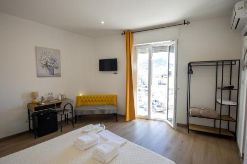 a bedroom with a bed and a desk and a window at Trapani Rooms 155 Self Check in in Trapani